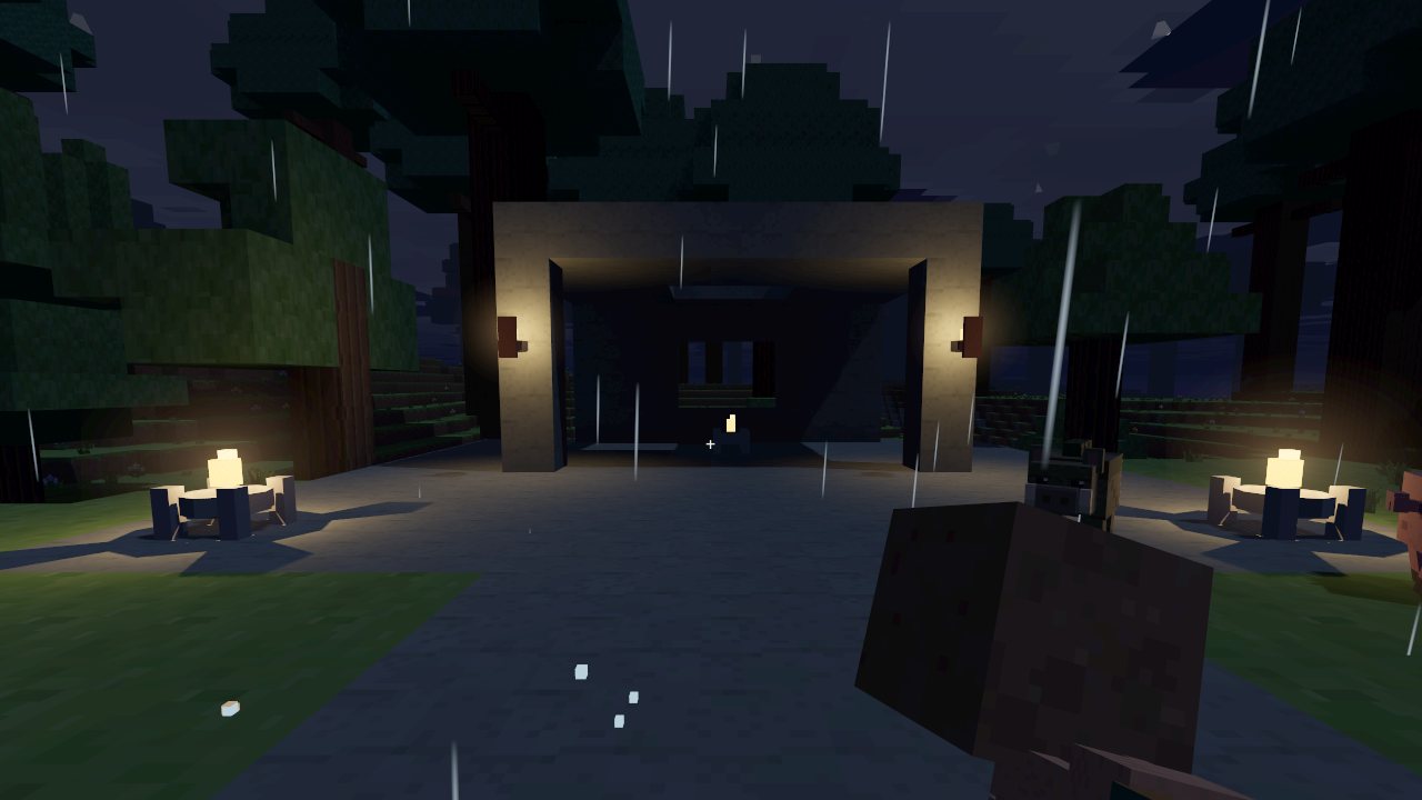 A courtyard at night, lit by fixtures that cast their own shadows.